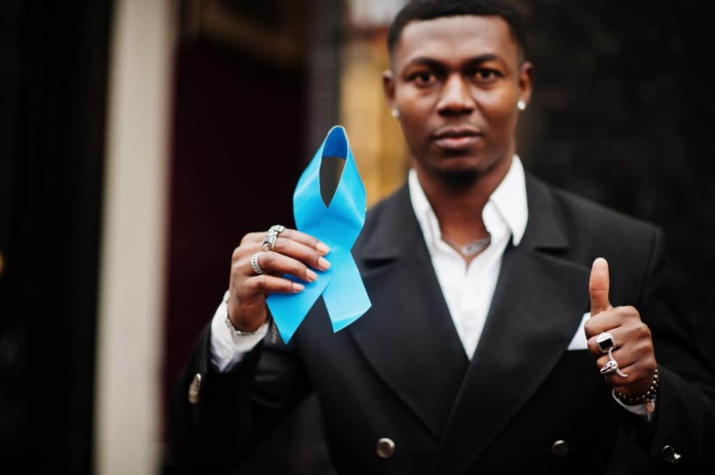 African american man hold blue prostate ribbon. Awareness cancer of men health.