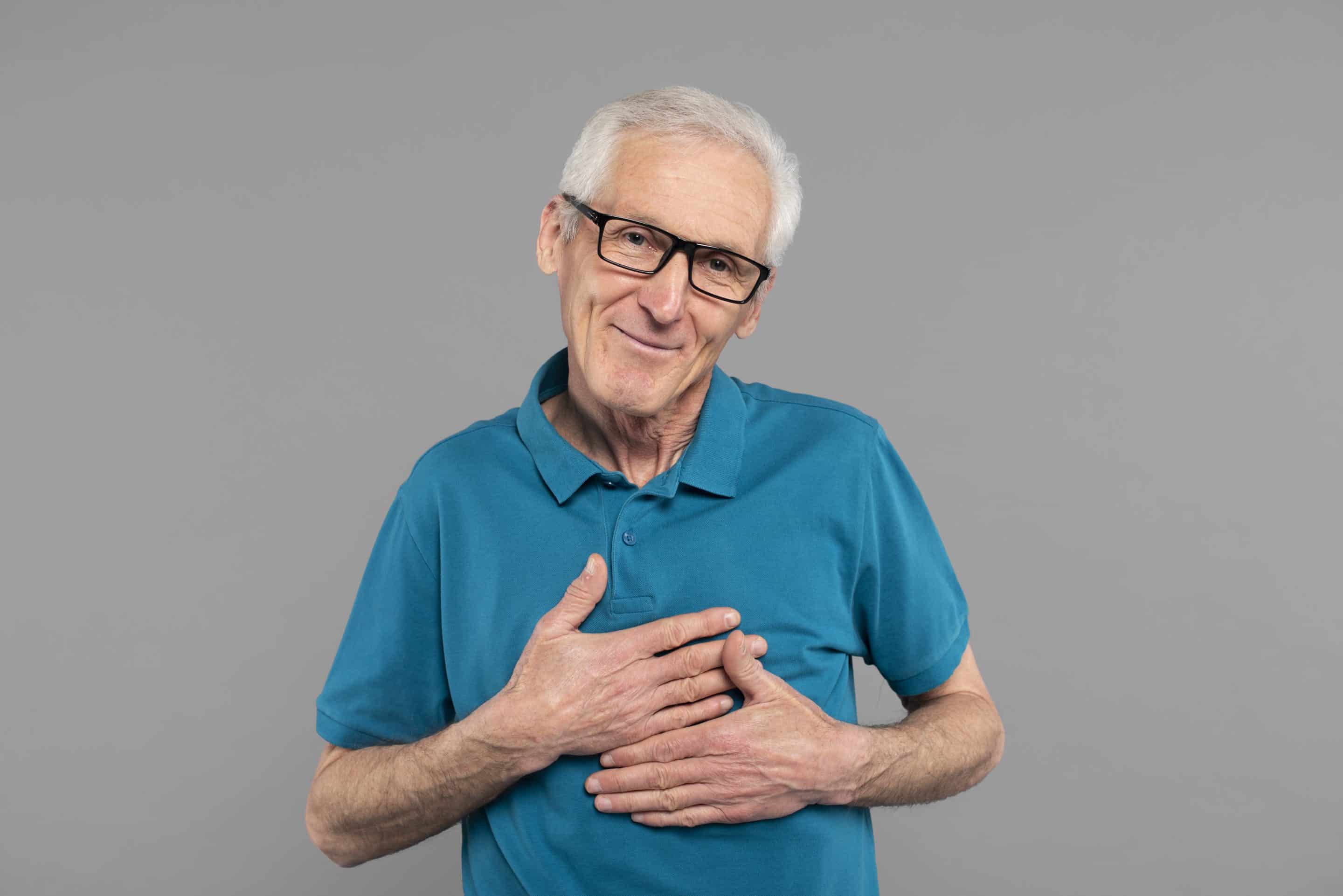 Senior man with hands over his heart. Aorta